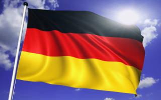 Deutsche Fahne vor wolkigem Himmel